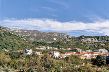 Scenic mountain town under clear blue sky with lush greenery