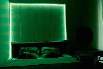 Modern bedroom with ambient green led lights and elegant design elements