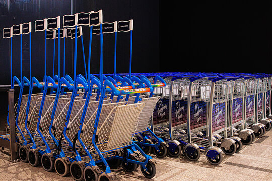 Helsinki, Finland, March 26th, 2025.Arrangement of airport shopping carts with Finavia and  Finnair logos. Luggage trolleys neatly lined at a modern airport terminal. Selective focus
