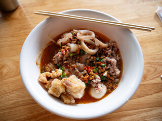 Tom Yum Seafood Noodles with Crispy Pork Cracklings or Pork Rinds.