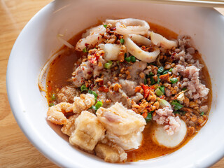 Tom Yum Seafood Noodles with Crispy Pork Cracklings or Pork Rinds.
