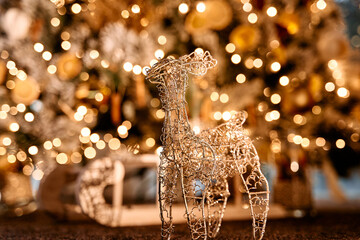 Shimmering wire reindeer sculpture with festive bokeh lights in the background