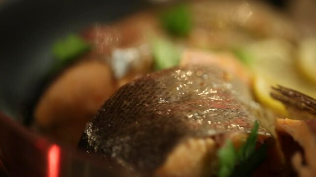 A chef meticulously plates a gourmet salmon fillet. This elegant and healthy dish is prepared in a professional kitchen, showcasing fine dining culinary artistry and presentation.