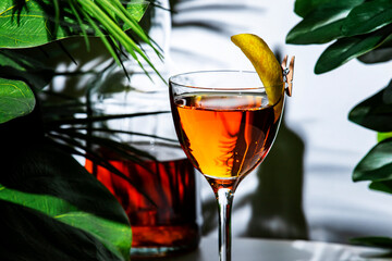 Savor the delightful flavors of La Perla cocktail with a twist of lemon, set against a backdrop of...