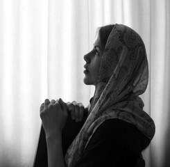 Young girl with bible praying to God