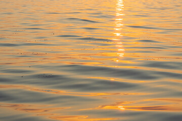waves in golden hour, reflections from sunset on the lake of Constance, beautiful colored waves...