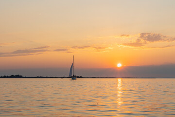 Sailing ship on Lake Constance before sunset, the sun illuminates the lake and conjures up intense...