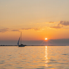 Sailing ship on Lake Constance before sunset, the sun illuminates the lake and conjures up intense...