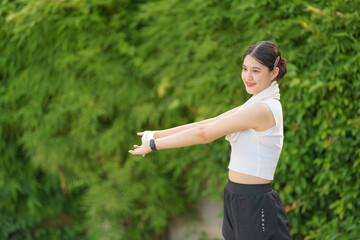 A woman in sportswear running in the park, enjoying fresh air, engaging in outdoor activities to maintain a healthy lifestyle, boosting cardiovascular health, and feeling happy and energetic.