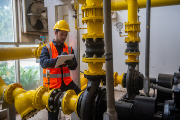 An engineer is inspecting a pressure motor pump and checking a gas pipeline pressure gauge