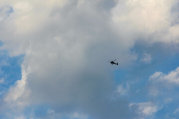 Overcast gray sky with dense clouds and small aircraft visible in atmospheric conditions