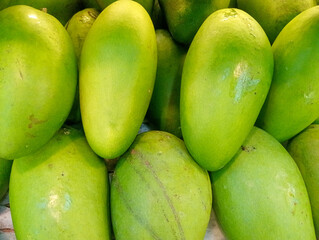 Manggo or manggo. Fresh green manggoes arranged at shelves supermarket for sale. Manggo is tropical fruit contains many vitamin. 