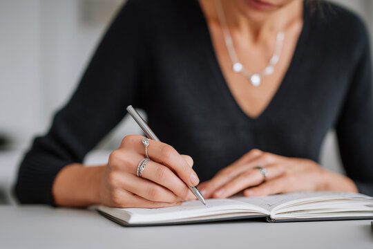 Jewelry designer sketching new collection in notebook, creative workspace, - Powered by Adobe
