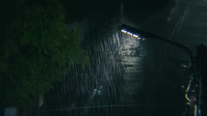 A fully functioning light bulb during heavy rain