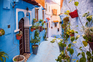Beautiful street with flowers in Chefchaouen, Morocco, the Blue city