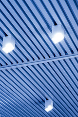 Ceiling with bright lights in a modern warehouse, shopping center building, office or commercial...