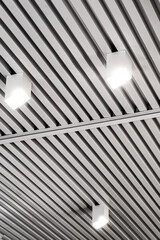 Ceiling with bright lights in a modern warehouse, shopping center building, office or commercial...