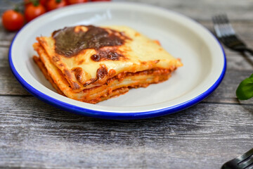   Delicious Home made Lasagna  with minced meat,tomato sauce and spinach  on a wooden rustic ...