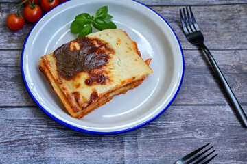   Delicious Home made Lasagna  with minced meat,tomato sauce and spinach  on a wooden rustic ...
