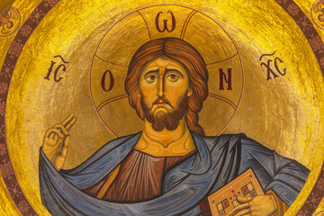 Lefkosia, Cyprus - 25 June 2025: View of a radiant depiction of Jesus Christ, his gaze serene, against a shimmering golden backdrop, halo glowing softly.