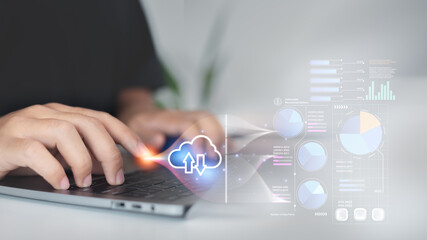 Close-up of hands typing on a laptop with an AI cloud computing icon and futuristic data analytics...