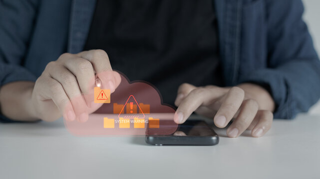 Close-up of a hand pointing at a cloud system warning alert on a smartphone screen, symbolizing cybersecurity threats, system errors, and data protection issues in digital technology.