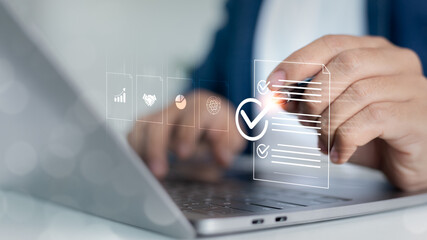 Close-up of a hand approving a digital checklist on a laptop screen, representing business...