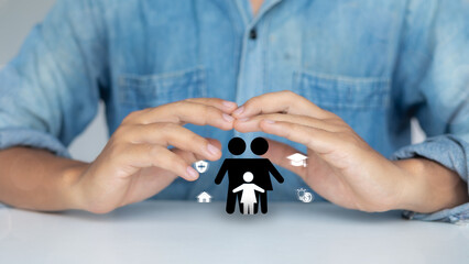 Close-up of hands protecting family icon with healthcare, home, education, and financial symbols,...