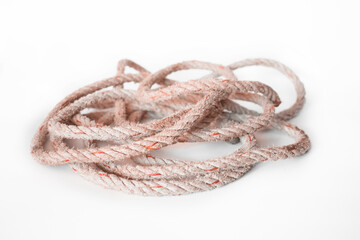 Old nylon rope roll on white background, looks frayed and crumpled.