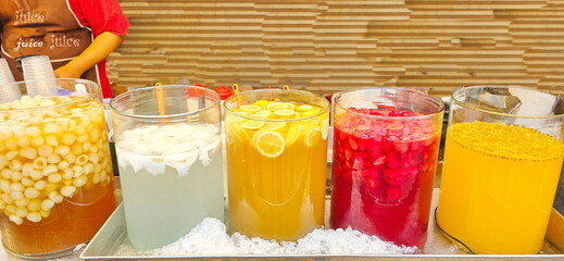 Fruit juice shop in street food. Many kinds of fruit juices longan, Young coconut water, orange...