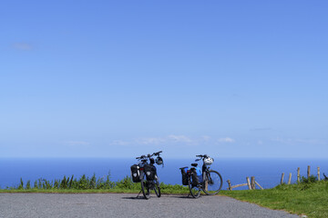 Bicycle trip by the sea. Two bicycles with panniers, concept of traveling in freedom.