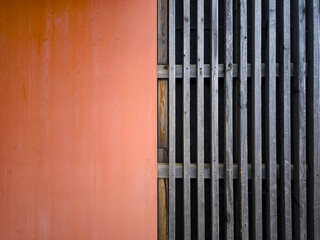 Minimalist Architectural Pattern With Contrast Of Orange Wall And Weathered Wooden Slats: Abstract...