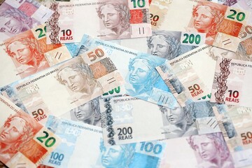 Brazilian reais banknotes. The current Brazil real money bills lies on table in big amount