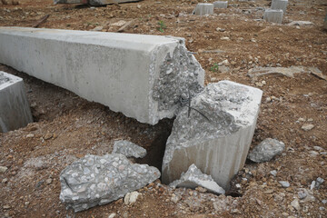 Prestressed concrete foundation piles are cut erratically above the ground. Cut off the remaining...