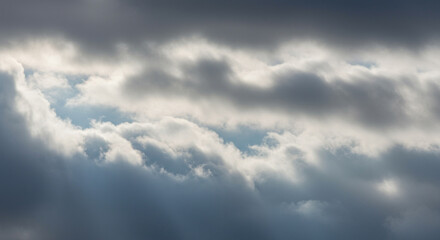 Obraz premium A close-up view of dramatic, textured clouds with patches of sunlight.