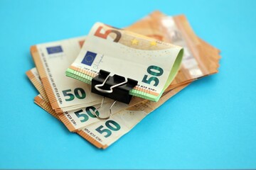 Big amount of european euro currency money notes on blue color table close up