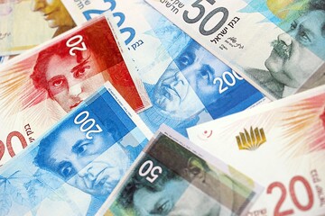 Israel New Shekels banknotes. The current Israel money bills lies on table in big amount