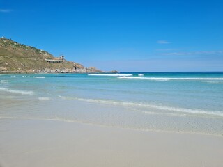 Praia Grande (Big Beach) Arraial do Cabo, Rio de Janeiro - Brazil: sunny morning, coastal atmosphere of the winter, white sand and crystal-clear blue waters in Brazilian Caribbean.