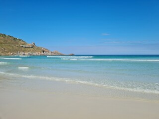 Praia Grande (Big Beach) Arraial do Cabo, Rio de Janeiro - Brazil: sunny morning, coastal atmosphere of the winter, white sand and crystal-clear blue waters in Brazilian Caribbean.