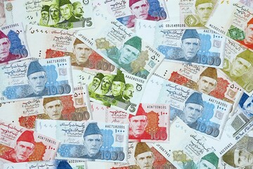 Pakistan rupees banknotes. The current Pakistan money bills lies on table in big amount