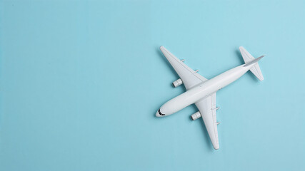 Minimalist white airplane model on blue background