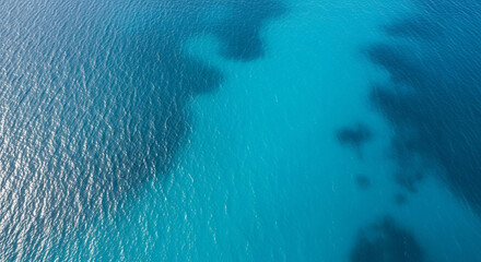 A breathtaking aerial view of the ocean's , showcasing a stunning gradient of turquoise and deep blue.