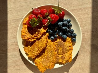 pumpkin fritters with fresh blueberries and strawberries for breakfast. High quality photo