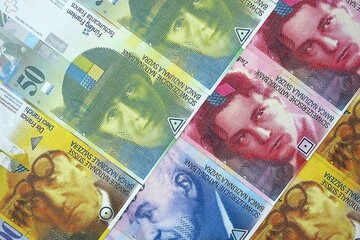 Swiss franc banknotes. The current francs money bills lies on table in big amount close up