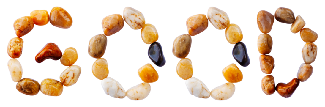 GOOD word is made of stone with a white background. The creative shapes of the letters of the alphabet are arranged with stones.	