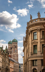 Iconic Cathedral Of Our Dear Lady In Munich: Majestic Twin Domes Rising Above Historic Buildings...