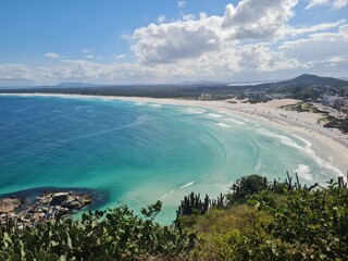 Fototapeta premium Praia Grande (Big Beach) Arraial do Cabo, Rio de Janeiro - Brazil: sunny morning, coastal atmosphere of the winter, white sand and crystal-clear blue waters in Brazilian Caribbean.