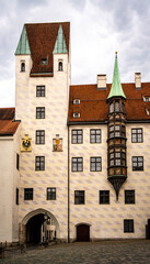 Historic Old Court In Munich With Medieval Architecture And Tower: Beautiful Facade With Red Tiled...