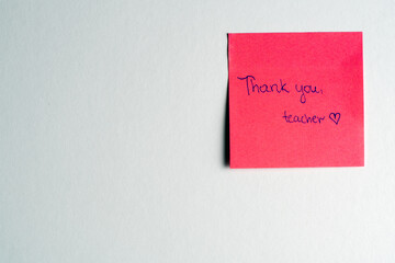 A vibrant red sticky note with 