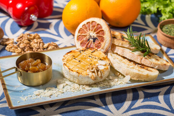 brie, with a golden, caramelized top and scattered almond slices and walnut pieces